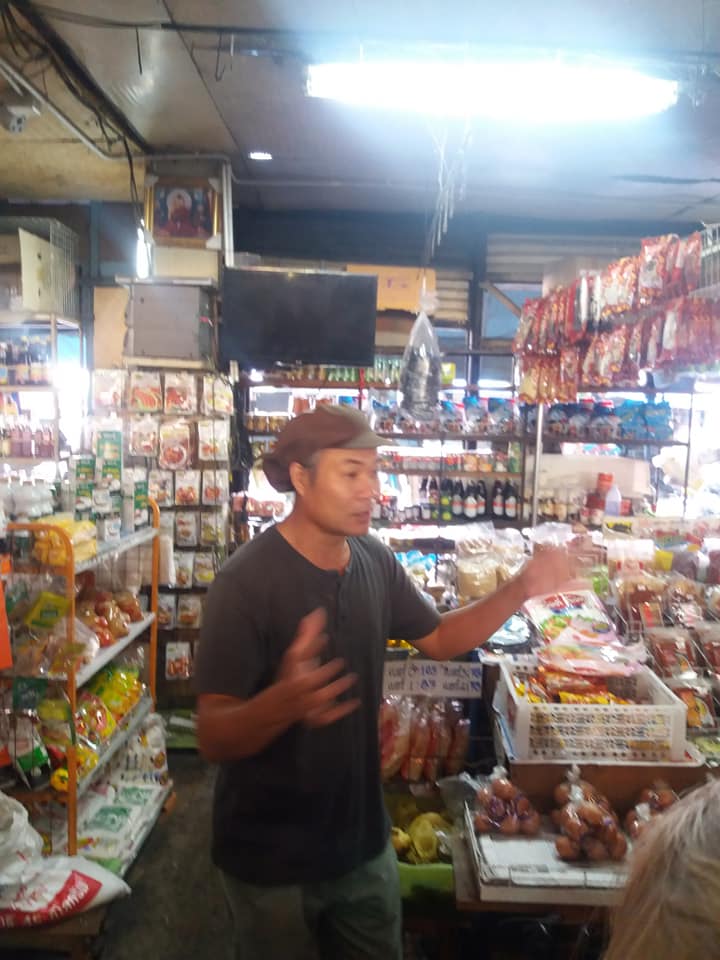 Sammy explaining the market produce